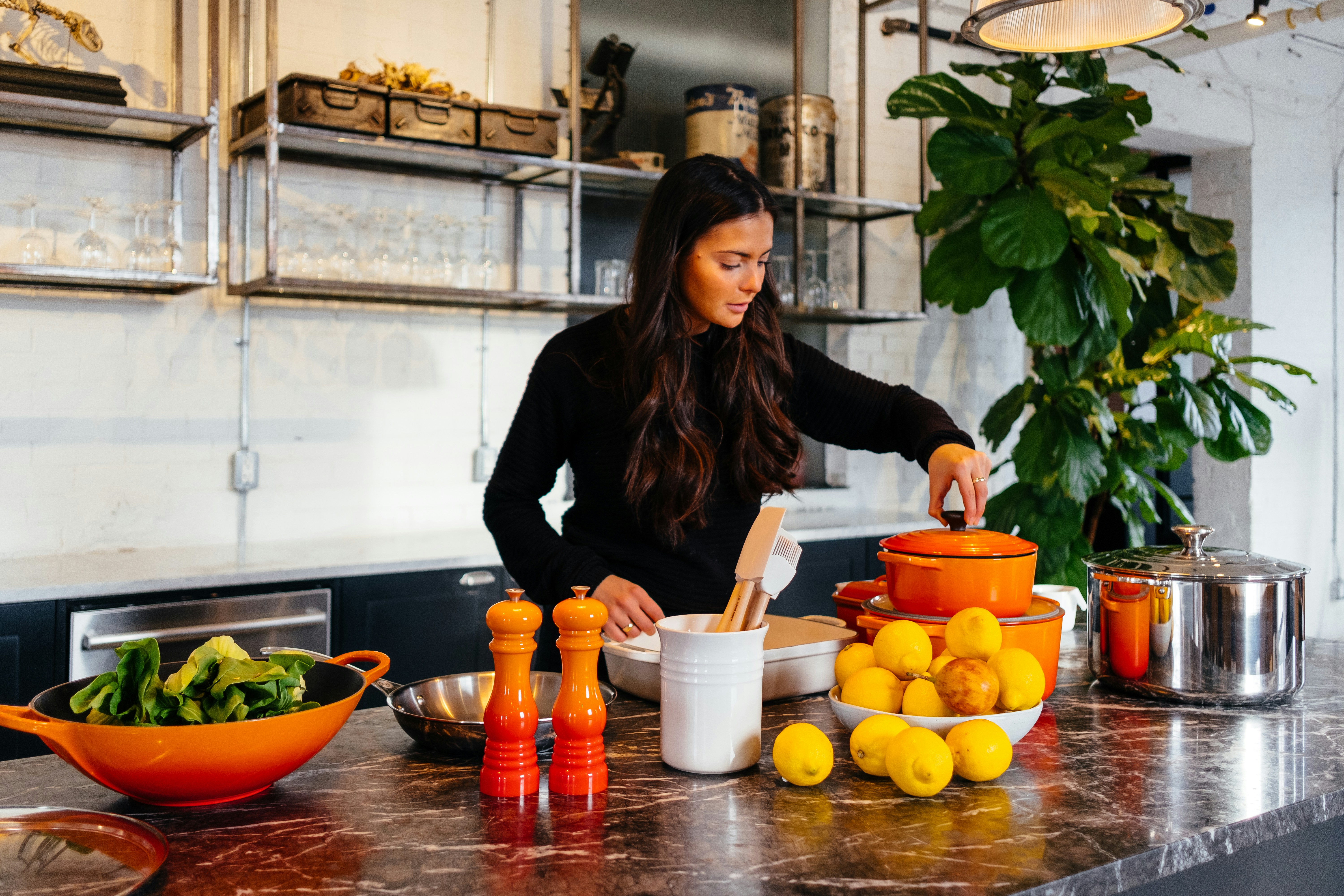 A person cooking with fresh produce in a kitchen